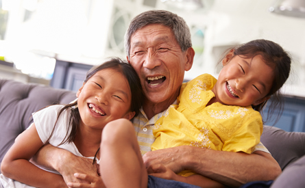 Korean grandfather hugging two girls